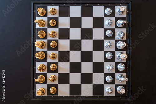 Carta da parati top view of chess pieces on a chessboard, business strategy concept