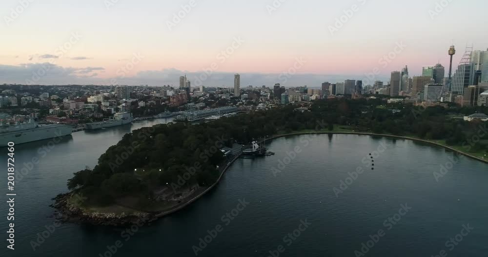 Royal Botanic Gardens and domain parks in Sydney at sunrise on shores of Harbour with waterfront of city CBD business towers.
Royal Botanic Gardens and domain parks in Sydney at sunrise on shores of Harbour with waterfront of city CBD business towers.