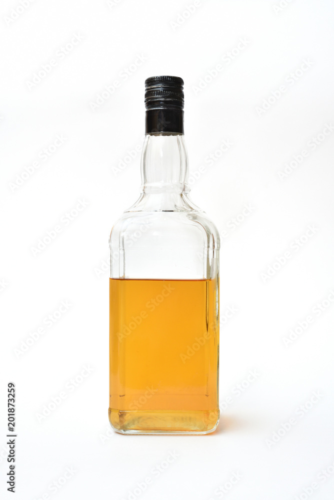 A clear bottle of alcohol, started. Half-empty bottle with alcohol on a white background A clear bottle of alcohol, started. Half-empty bottle with alcohol on a white background