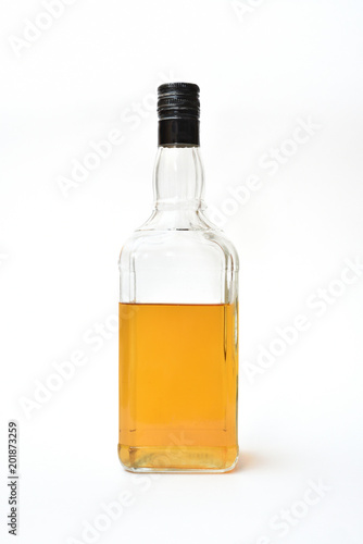 A clear bottle of alcohol, started. Half-empty bottle with alcohol on a white background