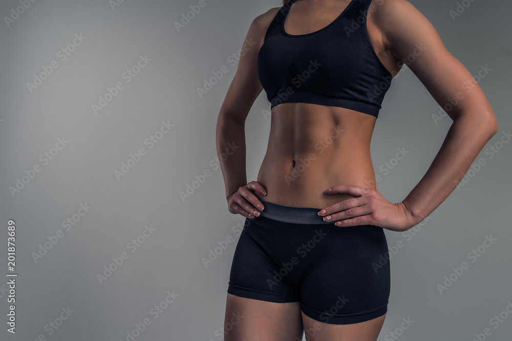 Close-up of sexy female figure, sports cubes press