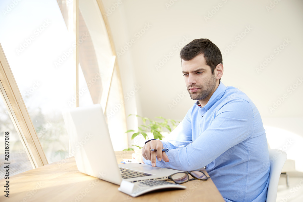 Young businessman working on laptop Young businessman working on laptop