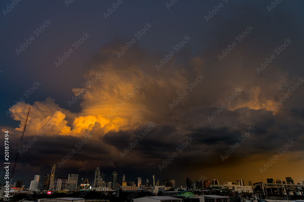 storm clouds above bangkok city with beautiful sunset light