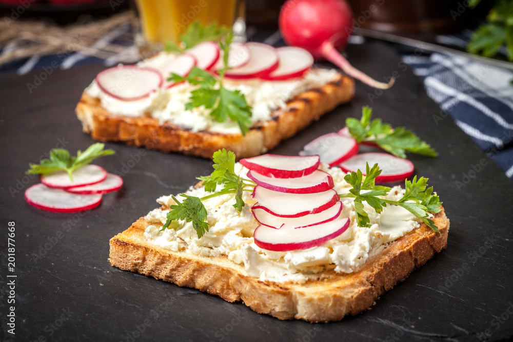 Light healthy sandwiches with bread toasts, soft cheese and freshly gathered organic radishes and parsley. Light healthy sandwiches with bread toasts, soft cheese and freshly gathered organic radishes and parsley.