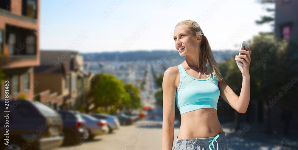 fitness, sport and technology concept - smiling young woman with smartphone exercising over san francisco city background