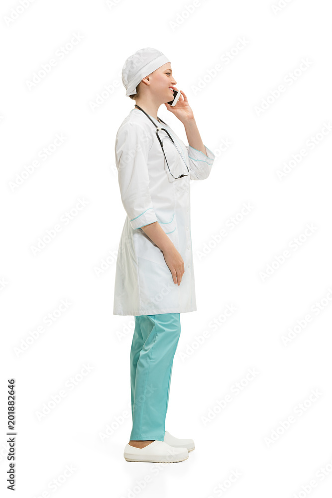 Beautiful young woman in white coat posing at studio. Full length studio shot isolated on white. Beautiful young woman in white coat posing at studio. Full length studio shot isolated on white.