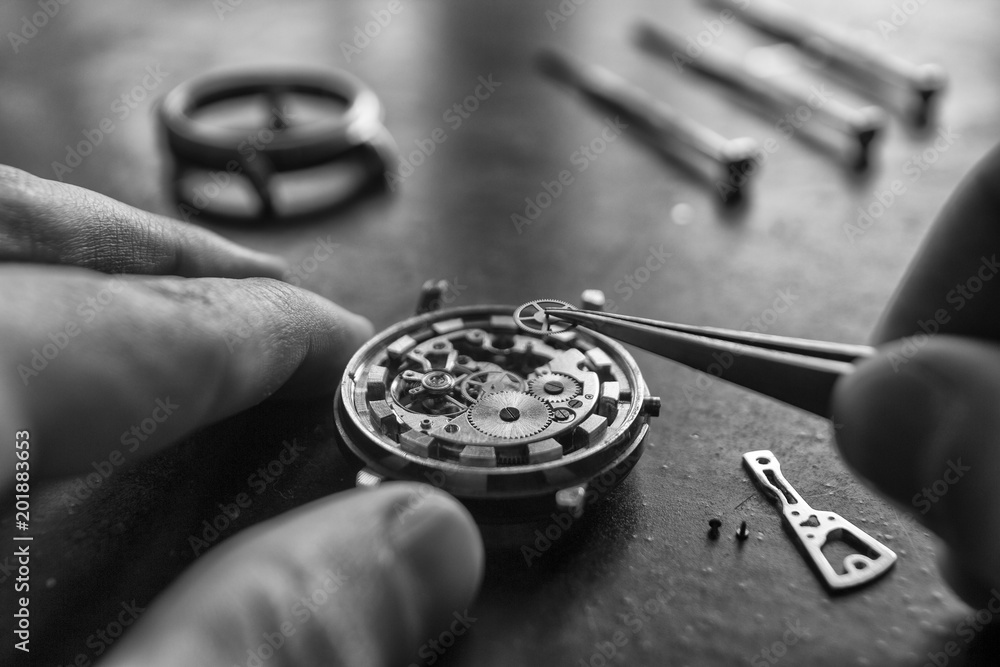 Watchmaker is repairing the mechanical watches in his workshop Watchmaker is repairing the mechanical watches in his workshop