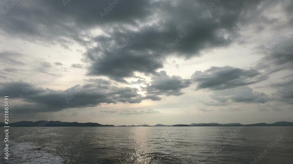 Sea wide shot on the boat with land on the horizon in far distance during and clouds Sea wide shot on the boat with land on the horizon in far distance during and clouds