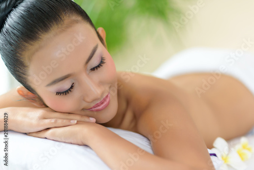 woman lying down relaxing on a massage bed at a spa