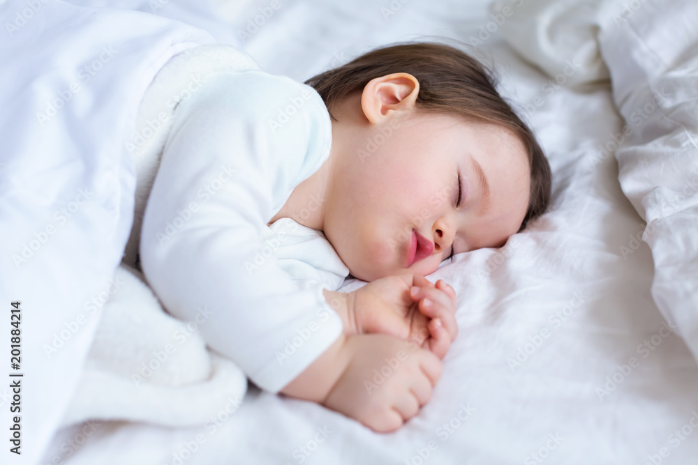 Sleepy toddler boy sleeping on his bed Sleepy toddler boy sleeping on his bed