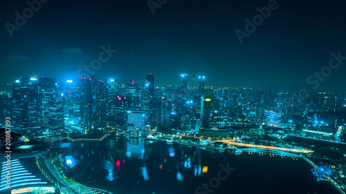Aerial drone view of Singapore skyscrapers with city skyline at night