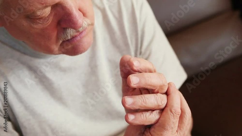 Senior man with involuntary hand movement