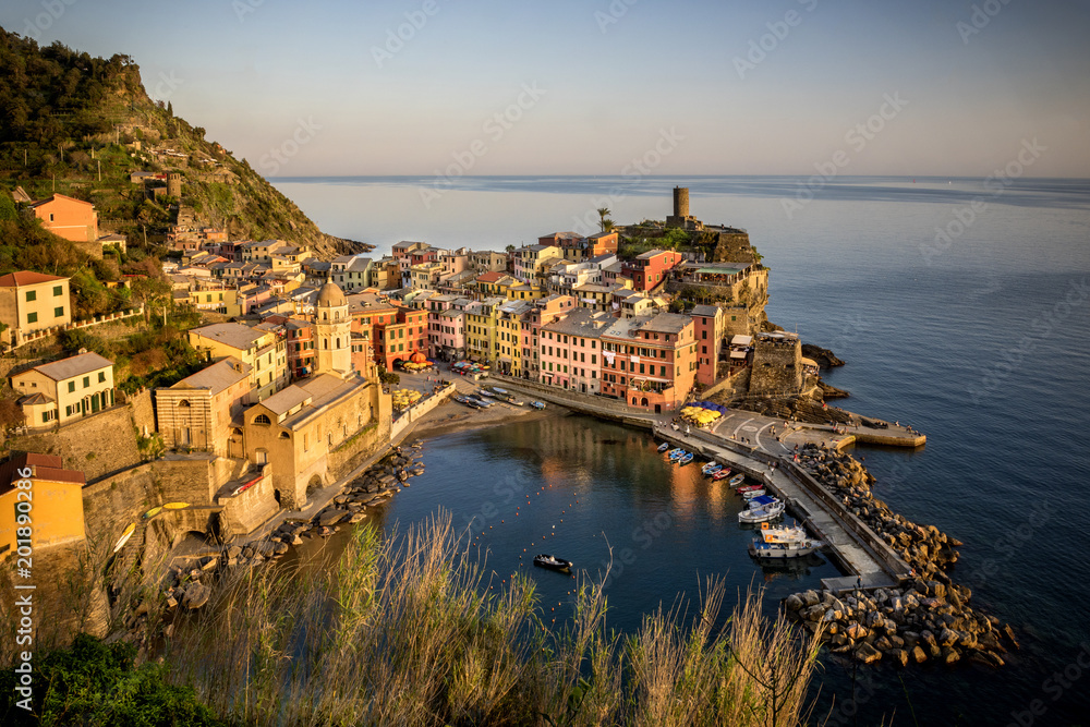 Vernazza fisherman village at sunset. Vernazza is one of five famous colorful villages of Cinque Terre in Italy, suspended between sea and land on sheer cliffs. Liguria, Italy