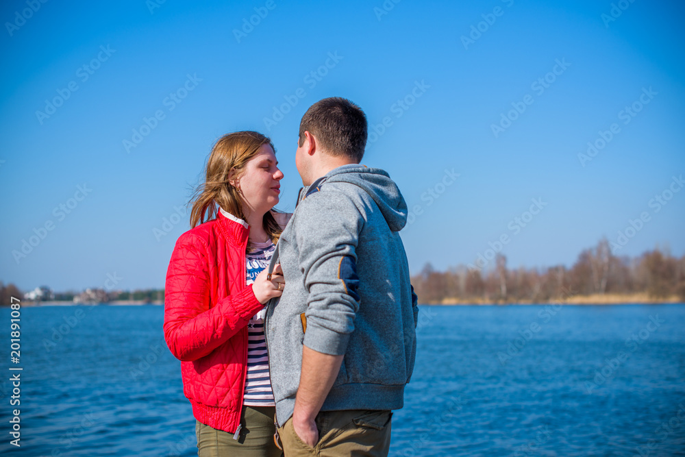 American young couple with overweight walk in park, man and woman together  