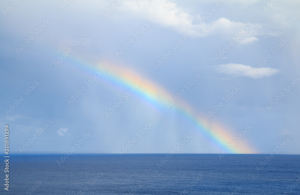 rainbow over the horizone at sea