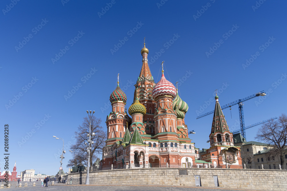 Moscow,Russia, St. Basil's Cathedral and Kremlin Walls and Tower in Red square in sunny blue sky. Red square is Attractions popular's touris in russia Moscow,Russia, St. Basil's Cathedral and Kremlin Walls and Tower in Red square in sunny blue sky. Red square is Attractions popular's touris in russia