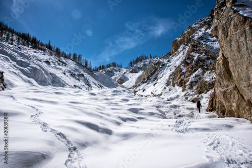 Wallpaper Mural Man walking on the snow with the background of snow mountain. Torontodigital.ca