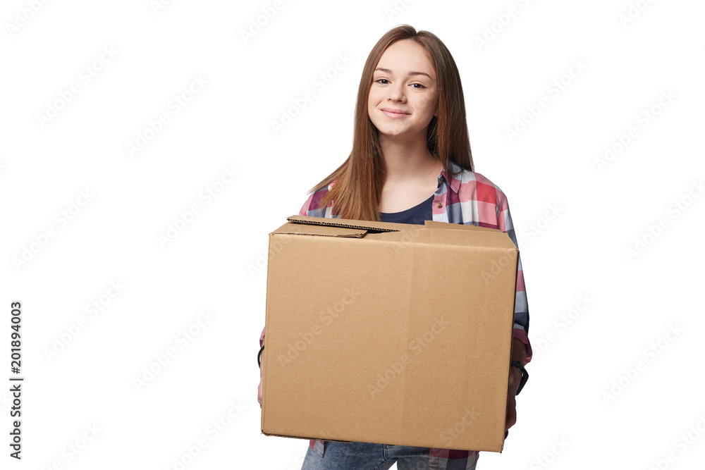 Delivery, relocation and unpacking. Smiling young woman holding cardboard box isolated on white background Delivery, relocation and unpacking. Smiling young woman holding cardboard box isolated on white background