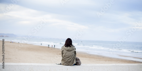 Mujer solitaria contemplando el mar photo