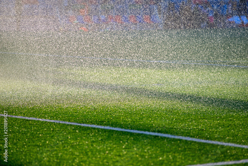 Irrigation turf. Sprinkler watering football field.