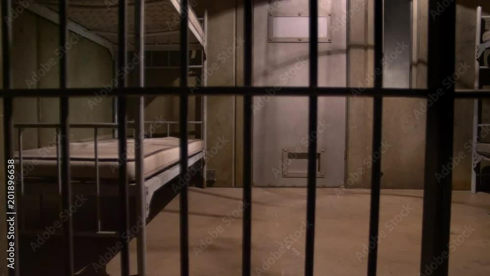 EMPTY JAIL CELL, SLIDER SHOT THROUGH THE BARS EMPTY JAIL CELL, SLIDER SHOT THROUGH THE BARS