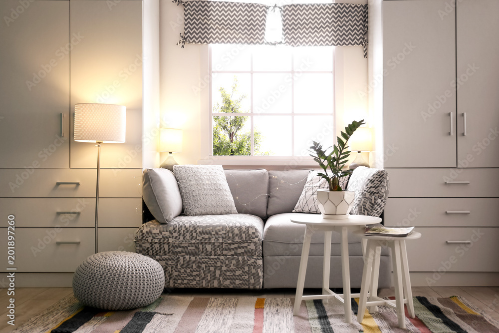 Fototapeta premium Stylish living room interior with comfortable sofa
