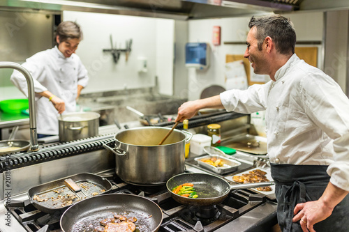 Chef and cook at work in a restaurant kitchen