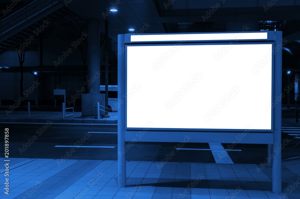 blank advertising billboard or light box with copy space for your text message or media and content in bus stop on street, information board, banner, marketing and advertising concept, blue color tone
