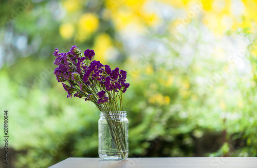 Purple flowers in glass bottles