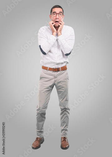 Valokuva Concerned young man with a gesture of scare - Full body shot