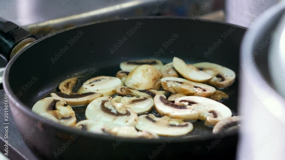 Chopped mushrooms fried in vegetable oil in the pan Chopped mushrooms fried in vegetable oil in the pan