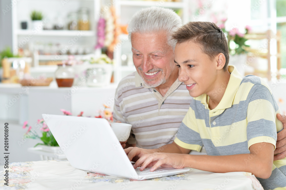 portrait of boy and grandfather with a laptop portrait of boy and grandfather with a laptop