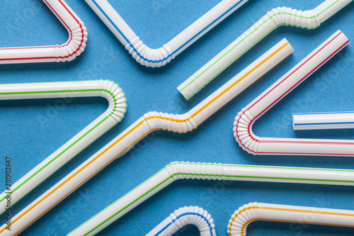 Plastic straws on a blue background photo
