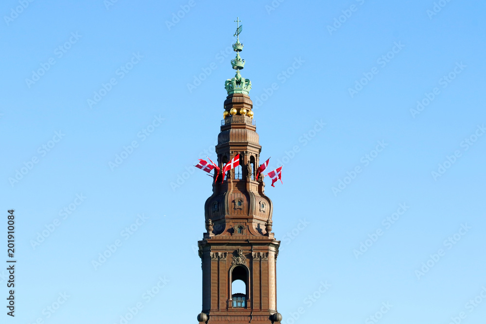 Danish flags on the tower. Christiansborg castle, Copenhagen, Denmark.