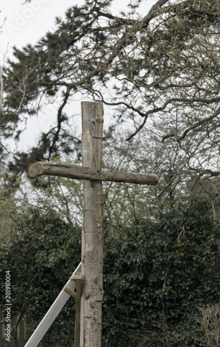Bare wood outdoor christian cross in the wood religious concept