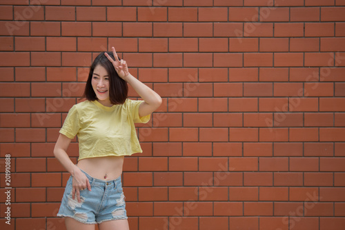 Portrait of beautiful asian chic girl pose for take a picture on brick wall,Lifestyle of teen thailand people,Modern woman happy concept