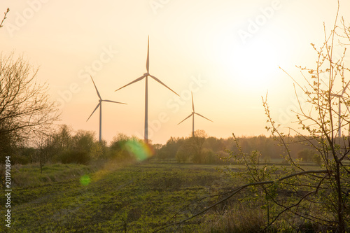 windmills in a farmland during sunset