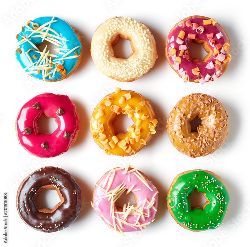 Various donuts isolated on white, from above
