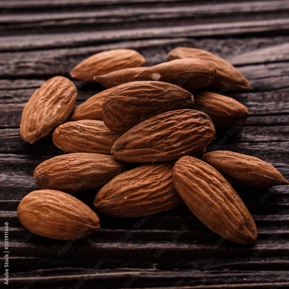 almond essential oil on a wooden background