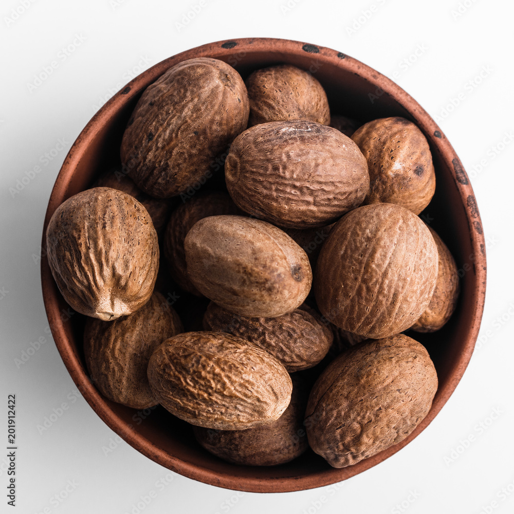 aromatic nutmeg on a white acrylic background aromatic nutmeg on a white acrylic background