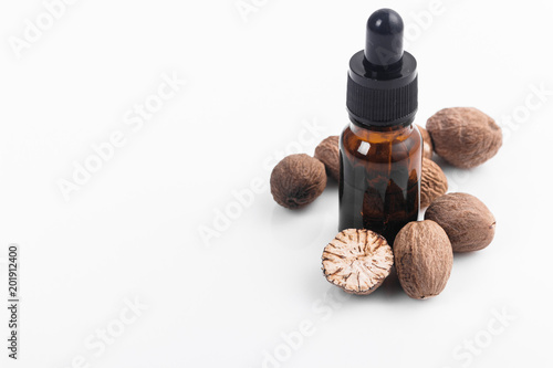 nutmeg essential oil on a white acrylic background