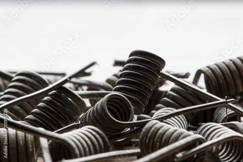 A close-up texture of a spiral for an electronic vaporizer and a cigarette. Vape, vaping photo