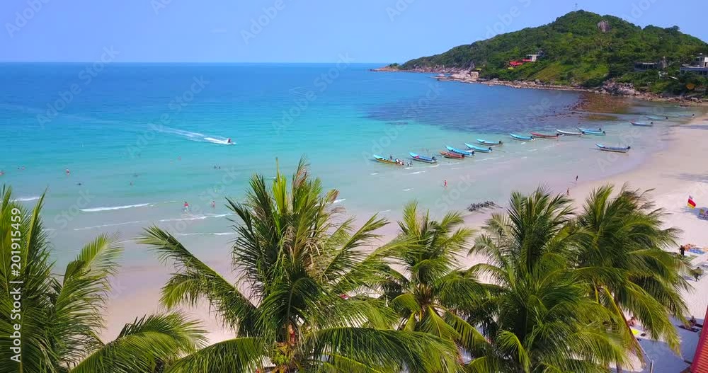 People enjoy summer time,group of long tail boats slowly moving on water at sandy beach of Thailand, koh Phangan island, Haad Rin beach line view.Static video People enjoy summer time,group of long tail boats slowly moving on water at sandy beach of Thailand, koh Phangan island, Haad Rin beach line view.Static video