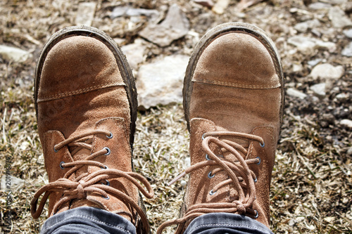 Old worn leather traveler's shoes at halt