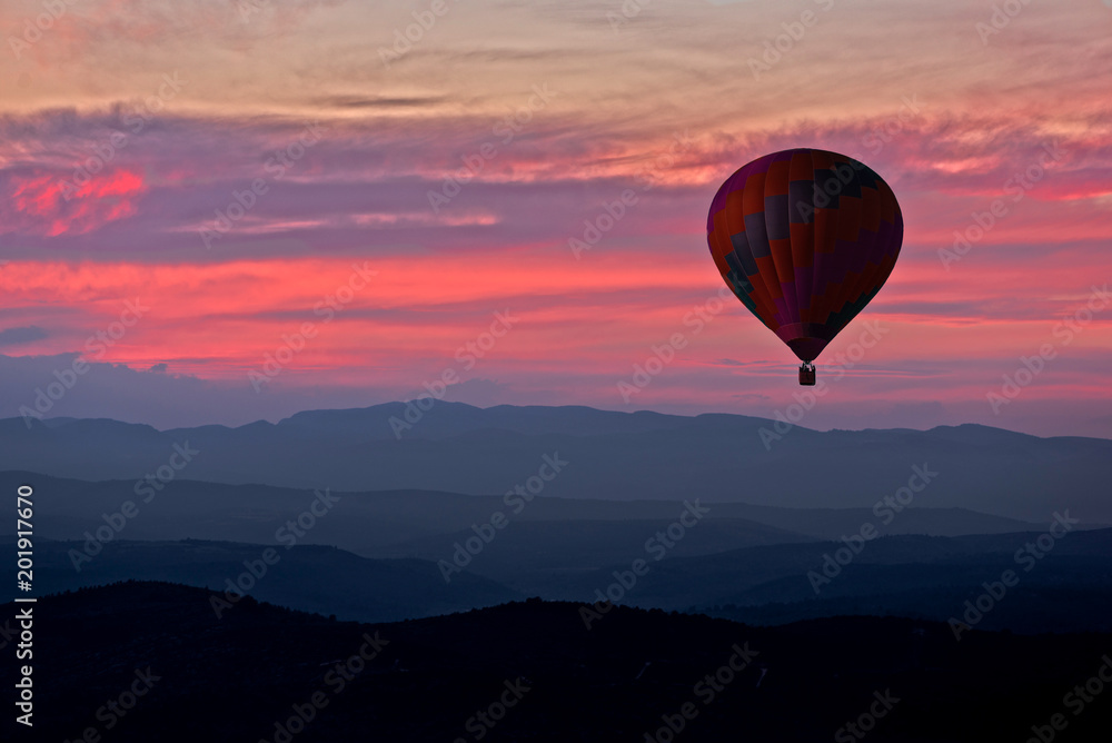 Aerostatic balloon with a red sunset in the background