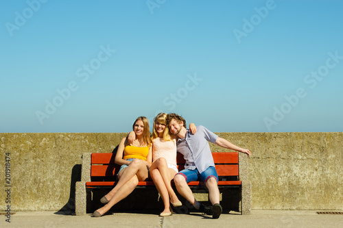 Three happy young people friends outdoor.