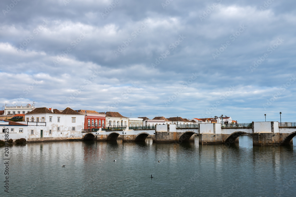 Historic buildings and famous Roman bridge in the center of Tavira, Portugal
