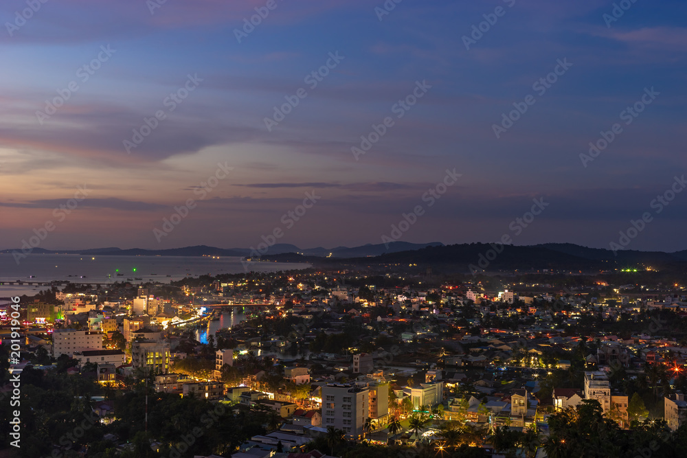 Aerial night scape view of Duong Dong town on Phu Quoc Island in Vietnam, streets with lights and bay