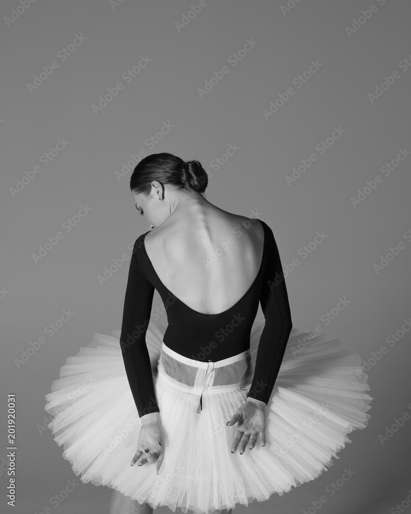 Fototapeta premium Young beautiful ballerina is posing in studio