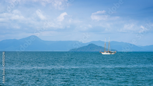 Beautiful sea view with boat against blue sky